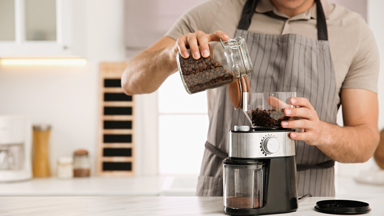 man grinding coffee beans