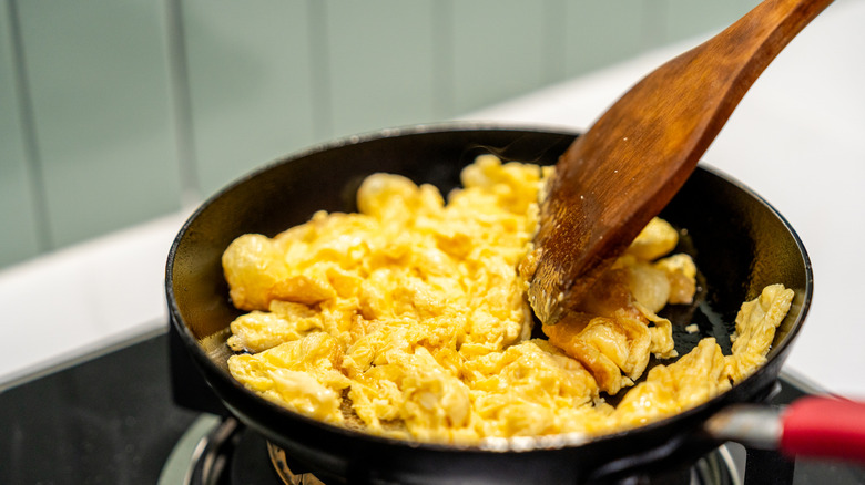 scrambling eggs in a pan
