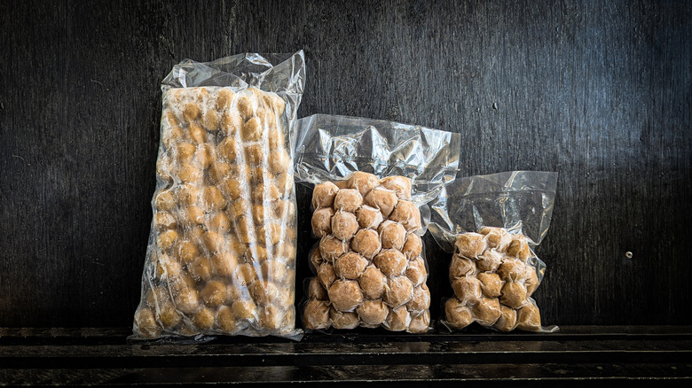 Frozen meatballs sit in three sizes of bags.