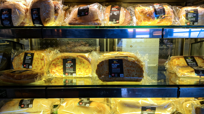 A selection of sandwiches in a Starbucks food display case
