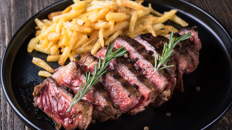 a plate of steak frites on a table