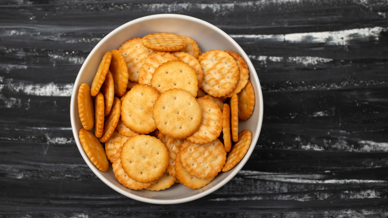 A white bowl full of Ritz crackers