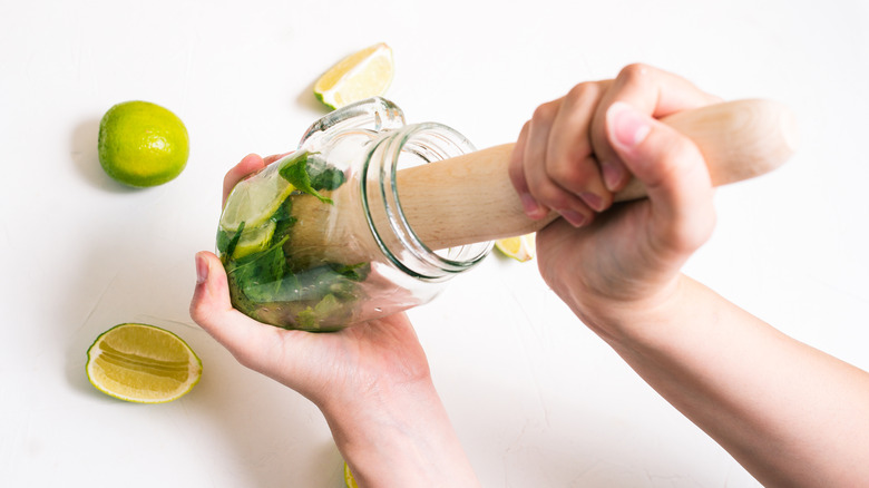 muddling mint in mason jar