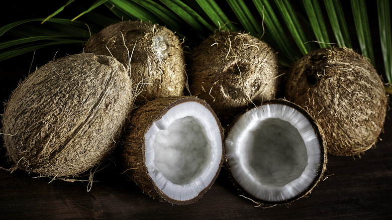 Halved and whole coconuts