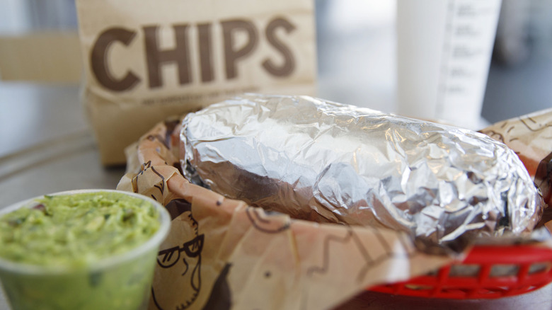 Chipotle burrito, guac, and chips