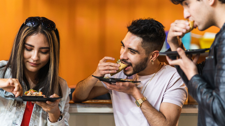 people eating tacos