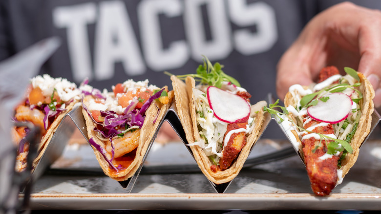 a sampling of tacos in a tray
