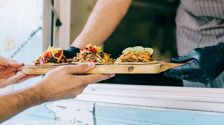 man accepting taco order