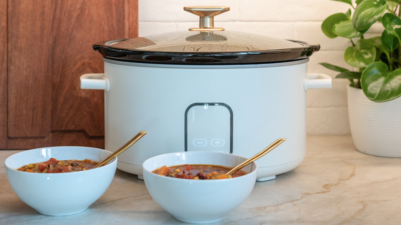 General blue slow cooker and bowls of food in a kitchen
