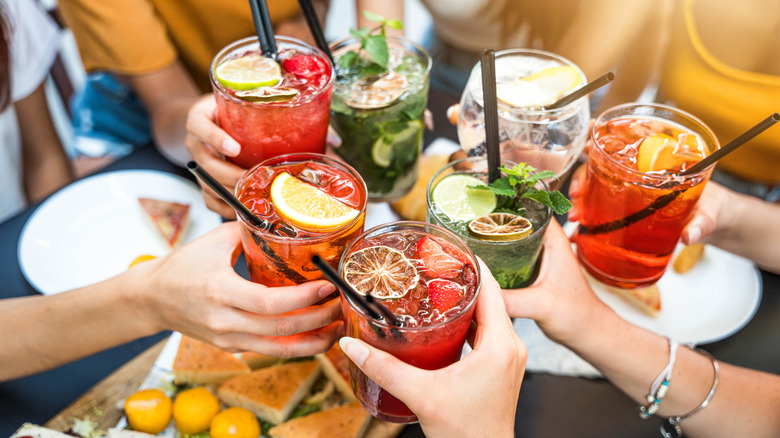 A group of people toasting cocktails