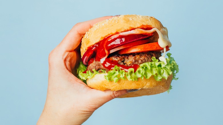 hamburger held by hand
