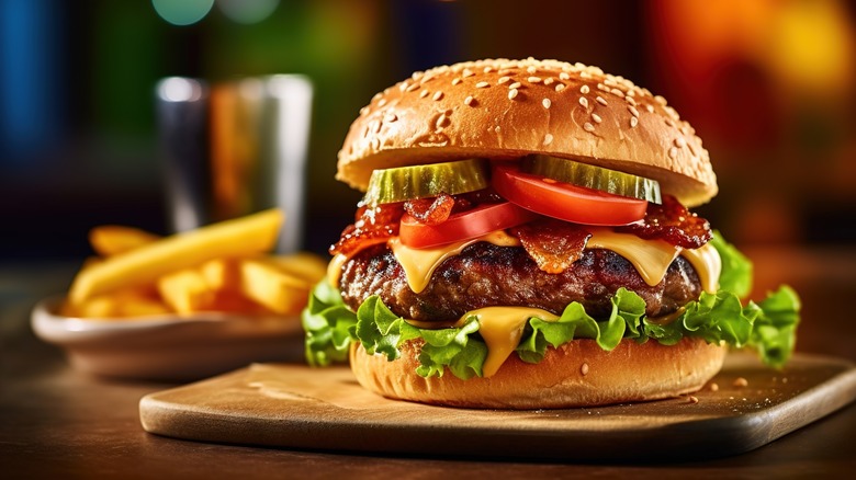 classic cheeseburger on wood plank