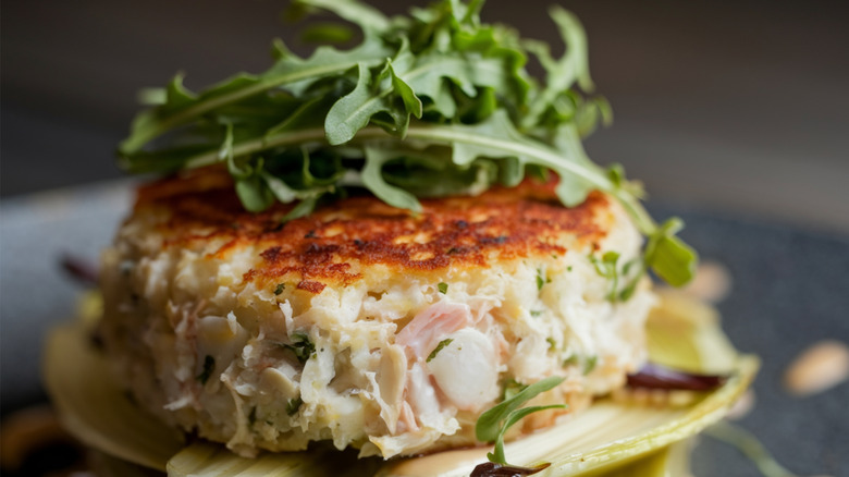 Tender crab cake topped with arugula