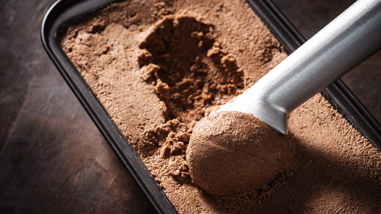 scooping homemade chocolate ice cream