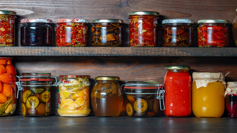 Different canned foods sitting on a pantry shelf