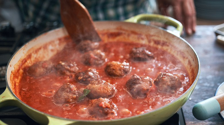 Meatballs cooking in marinara