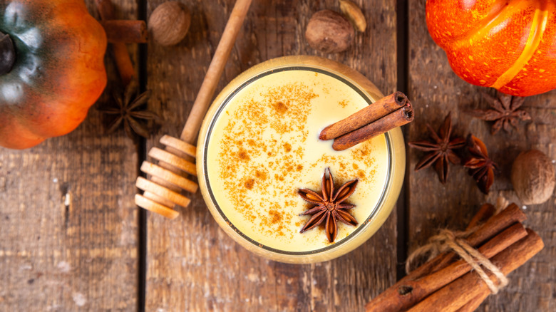 Ariel view of eggnog garnished with cinnamon and star anise.