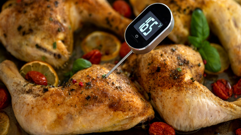 A digital meat thermometer displaying a cooking temperature for chicken