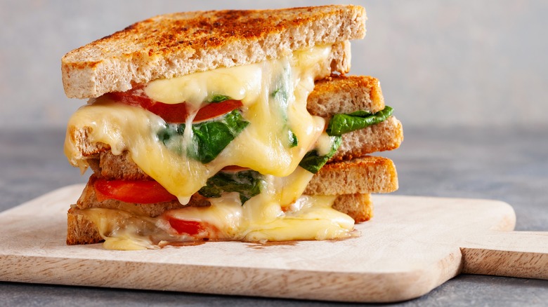 melty cheese, tomato, and spinach sandwich