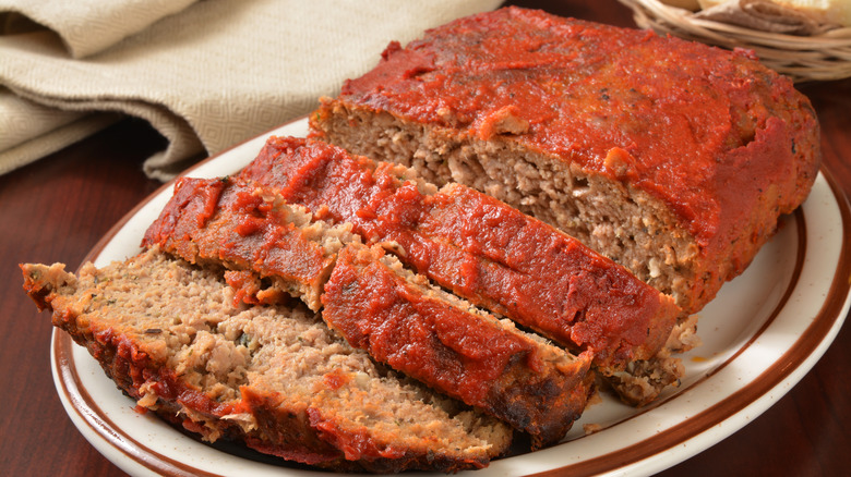 A whole meatloaf with a few pieces sliced off