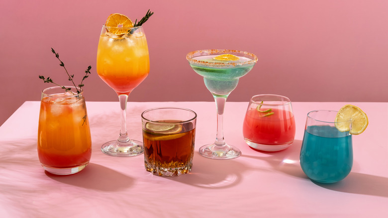 Variety of cocktails on pink table with pink background