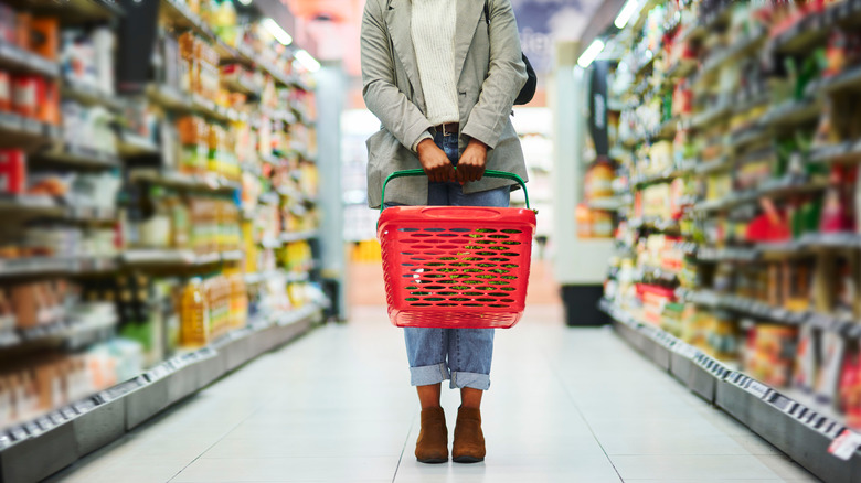 Woman grocery shopping, wearing mask
