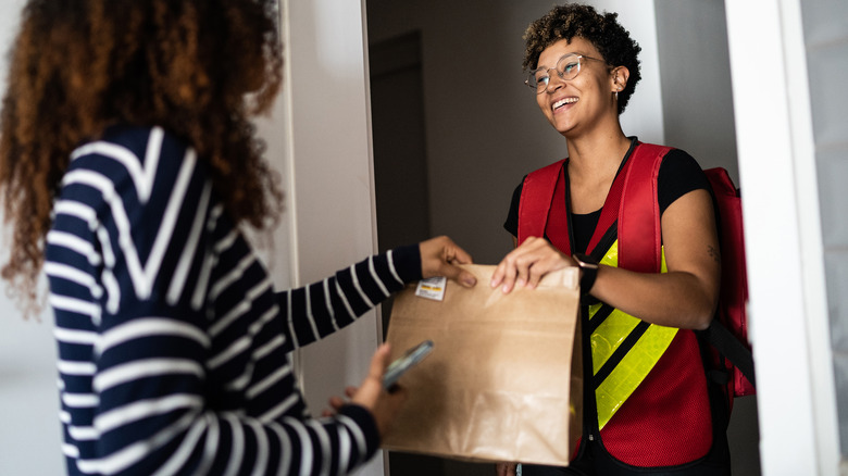 Delivery person dropping off takeout