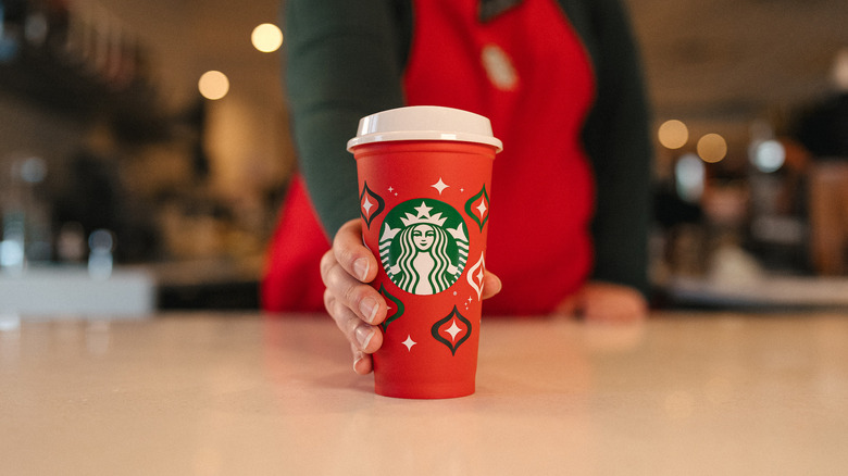 barista serving holiday drink at Starbucks