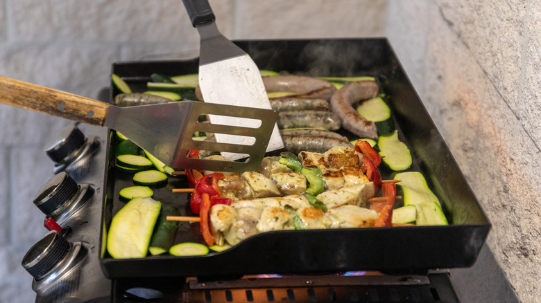 Kebabs on griddle over grill