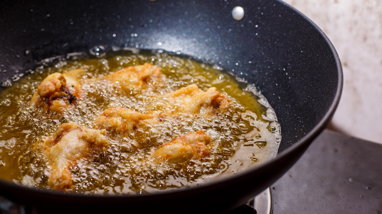 chicken wings frying in oil
