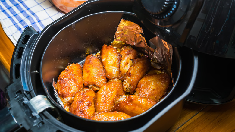 wings cooking in an air fryer