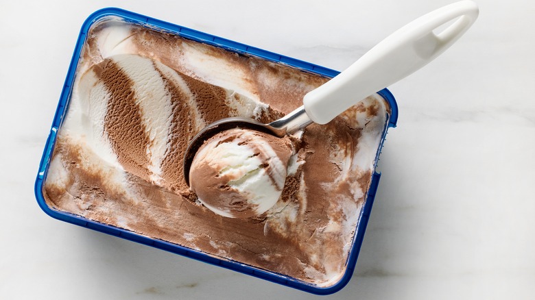 Vanilla and chocolate ice cream being scooped
