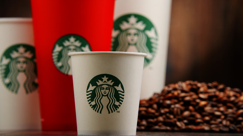 Starbucks cups with coffee beans