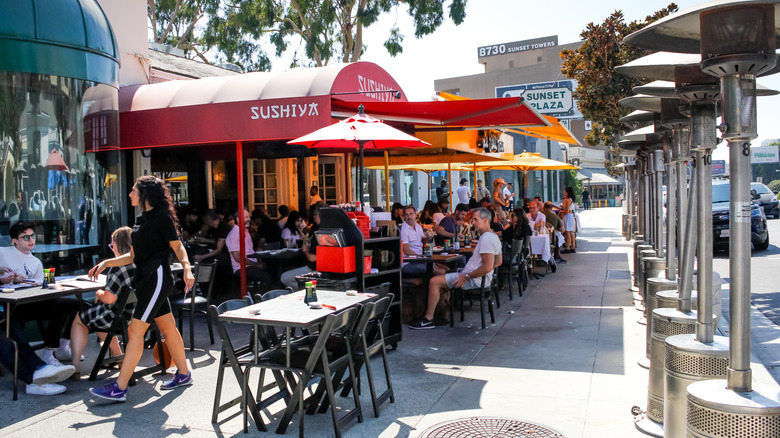 Multiple restaurants with outdoor dining next to each other.