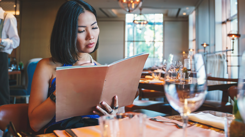 Diner reading a restaurant menu