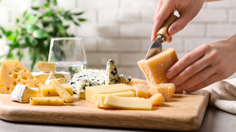 Assorted cheeses on cutting board