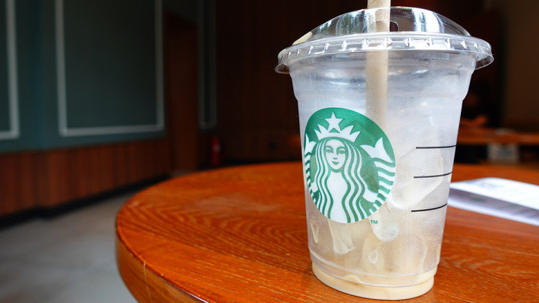 Empty Starbucks iced coffee cup filled with ice cubes