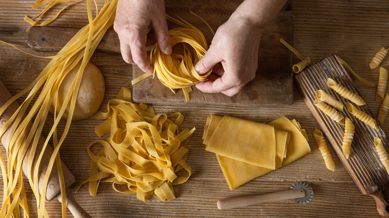 hands making fresh pasta shapes