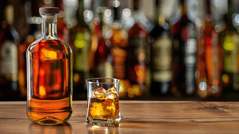 Whiskey bottle and glass on counter