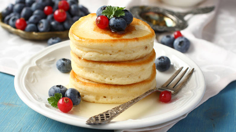 Stack of fluffy pancakes with berries