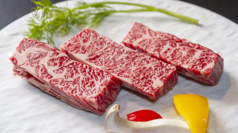 Three slices of raw Kobe beef.
