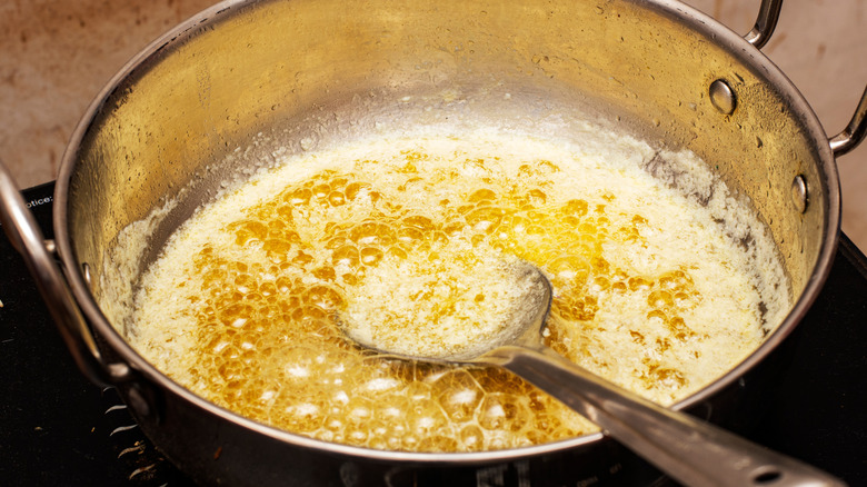 Close up of a pot of butter simmering to make clarified butter