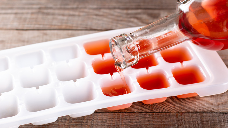 pouring red wine into ice cube tray