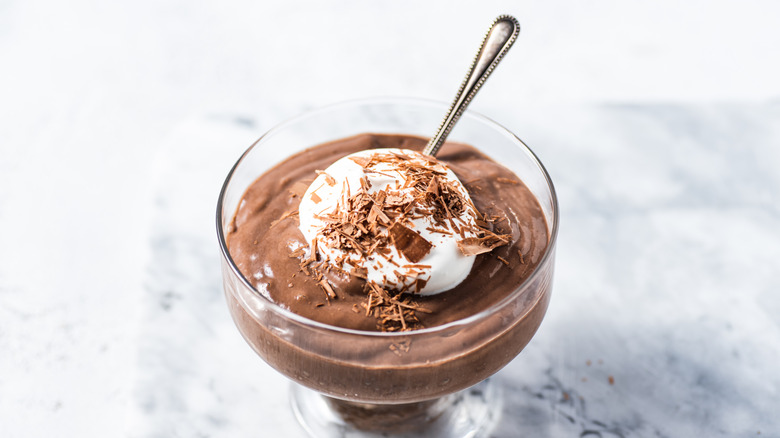 Chocolate pudding in a glass with a spoon inside