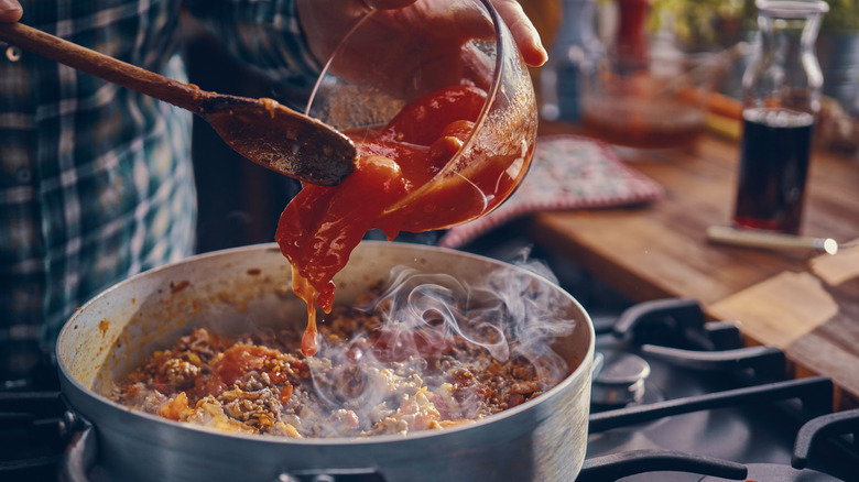 Watery tomato sauce poured into pan