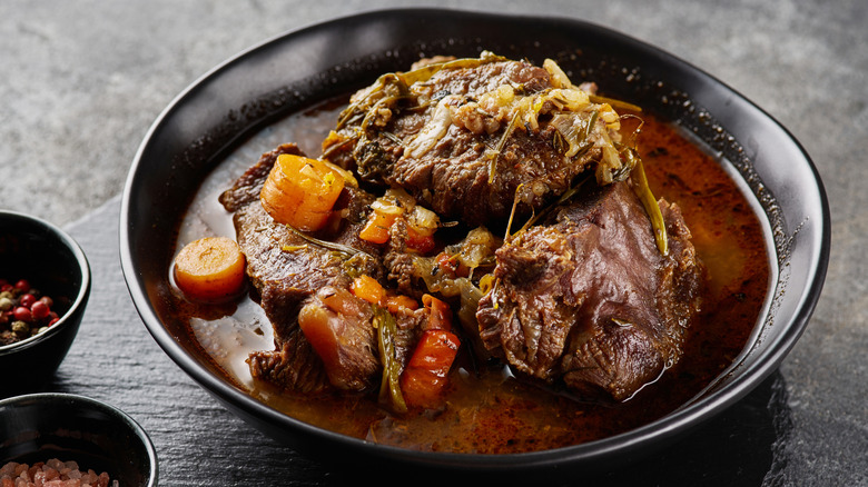 A bowl of German pot roast with carrots