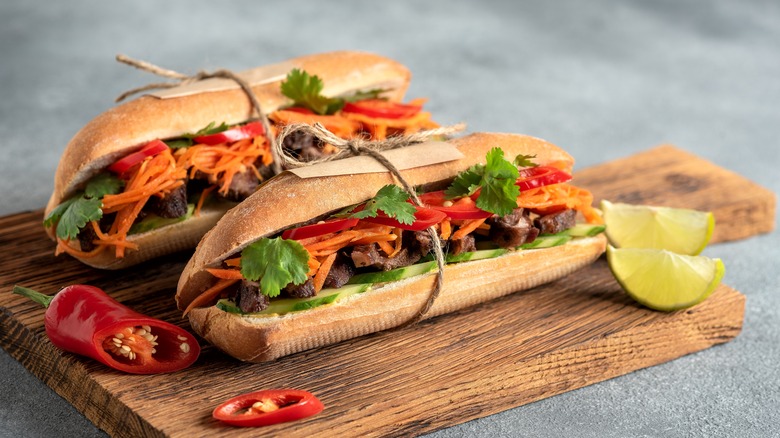 Two bahn mi sandwiches on a cutting board