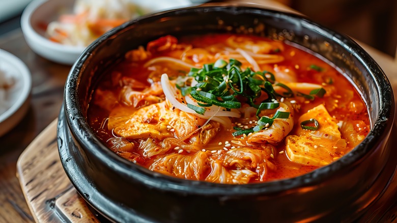 A bowl of Korean jjigae on a table