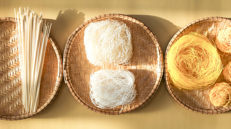 Various types of raw noodles in baskets