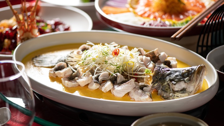 steamed whole fish in broth with scallions and ginger